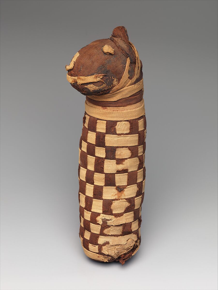 Sacred animal mummy containing dog bones, Dyed and undyed linen, animal remains, mummification materials 