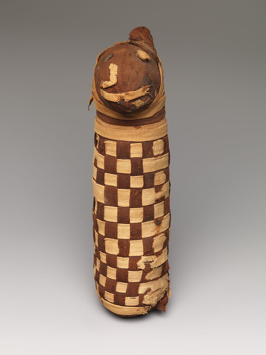 Sacred animal mummy containing dog bones, Dyed and undyed linen, animal remains, mummification materials