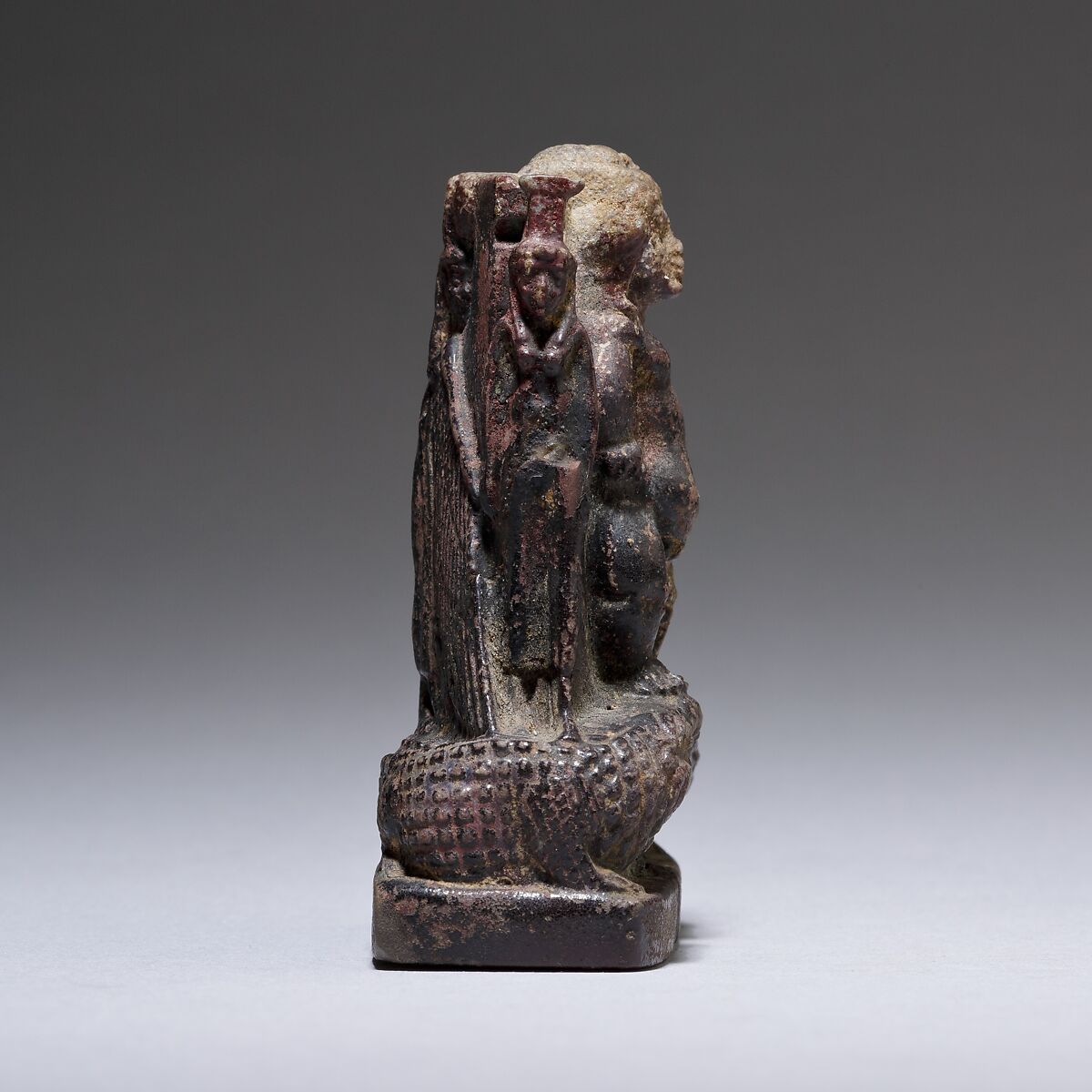 Cippus (magical stela) where Pataikos replaces Horus on the crocodiles and is flanked by Isis and Nephthys, Faience