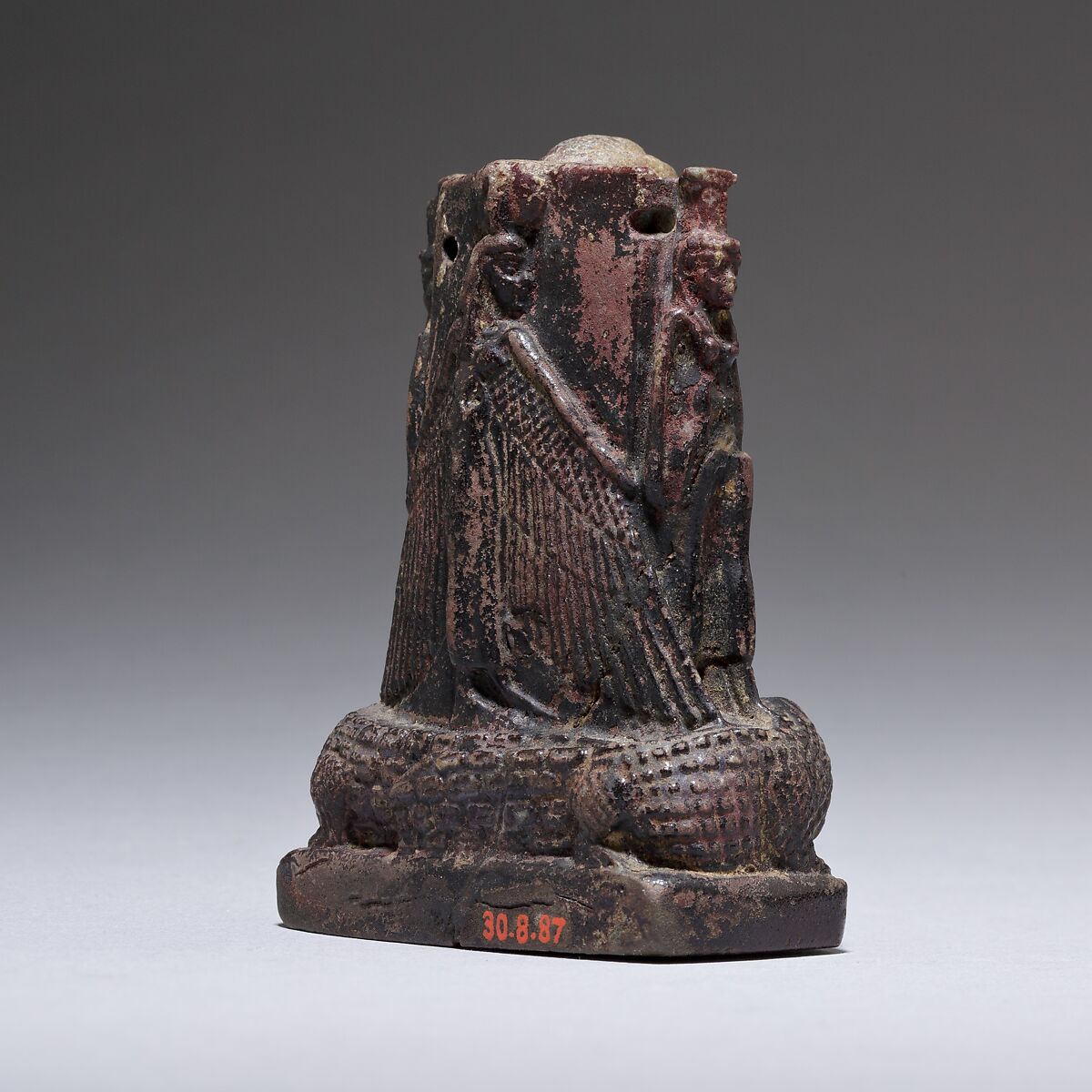 Cippus (magical stela) where Pataikos replaces Horus on the crocodiles and is flanked by Isis and Nephthys, Faience