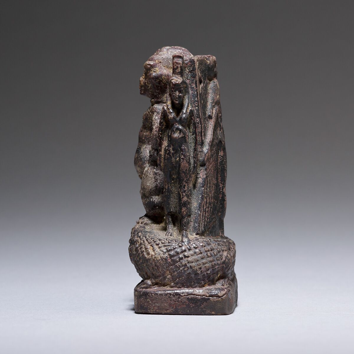 Cippus (magical stela) where Pataikos replaces Horus on the crocodiles and is flanked by Isis and Nephthys, Faience