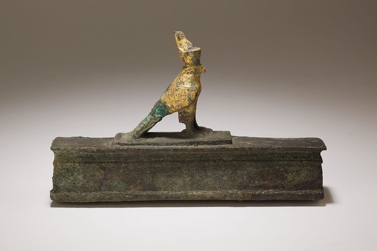 Falcon in double crown surmounting a shrine shaped box for an animal mummy, Cupreous metal, precious metal