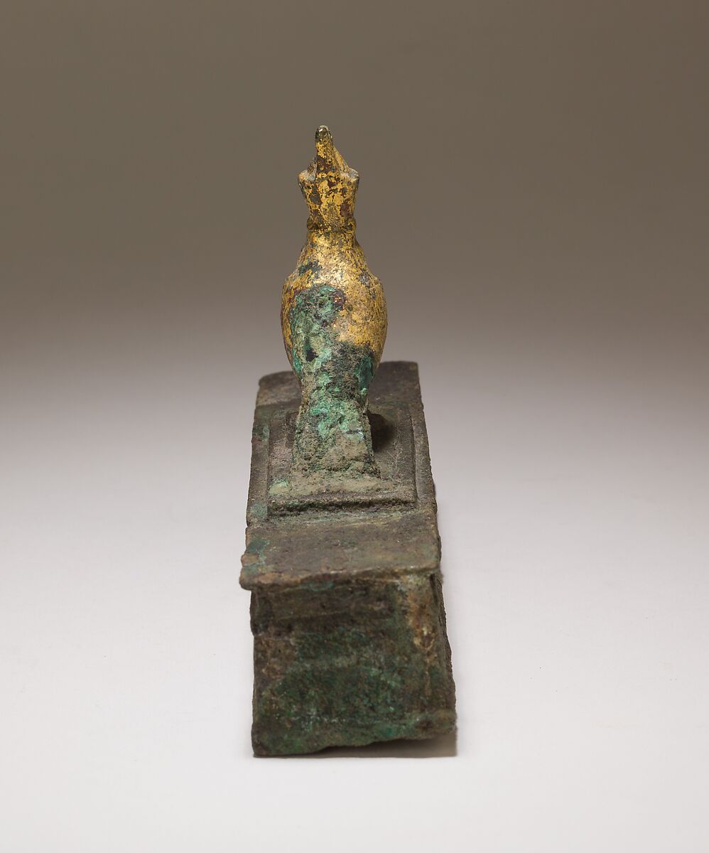 Falcon in double crown surmounting a shrine shaped box for an animal mummy, Cupreous metal, precious metal