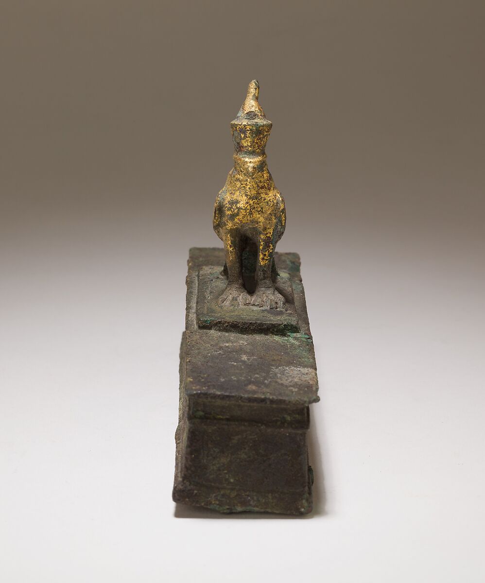 Falcon in double crown surmounting a shrine shaped box for an animal mummy, Cupreous metal, precious metal