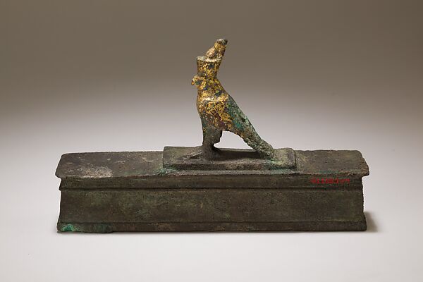 Falcon in double crown surmounting a shrine shaped box for an animal mummy