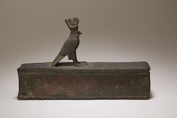 Case for an animal mummy topped by a falcon