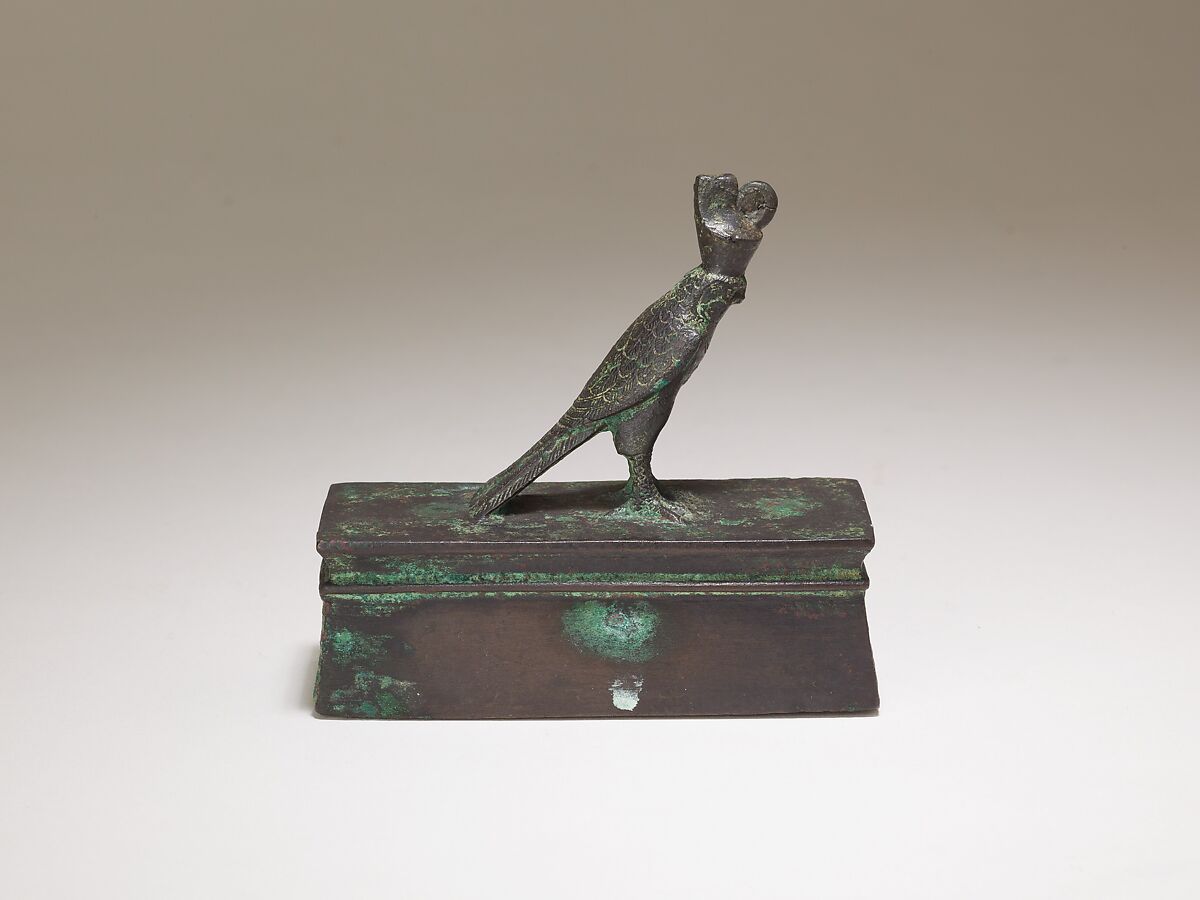 Falcon in double crown surmounting a shrine form box for an animal mummy, Cupreous metal 