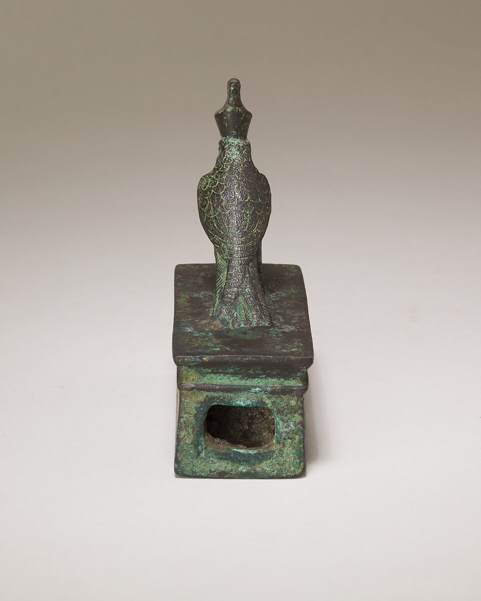 Falcon in double crown surmounting a shrine-shaped box for an animal mummy, Cupreous metal