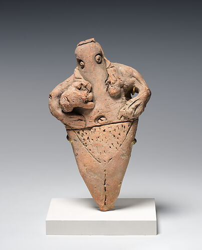 Female figure holding infant