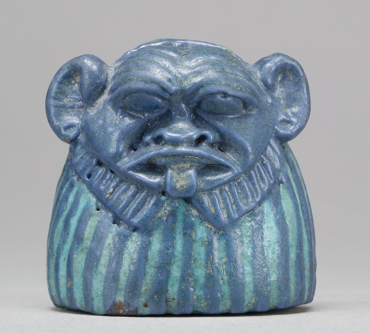 Part of a Mirror Handle depicting Bes, Faience 