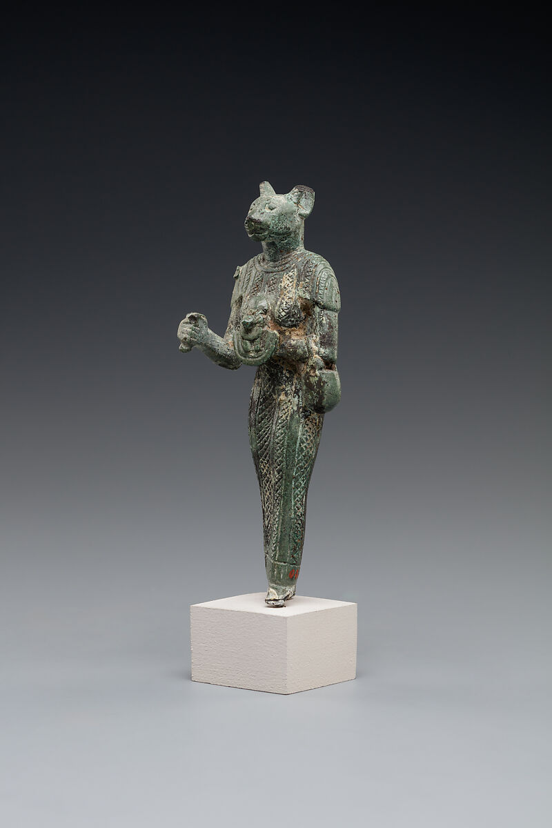 Bastet holding a lion-headed aegis, a sistrum (broken), and a basket, Bronze or copper alloy