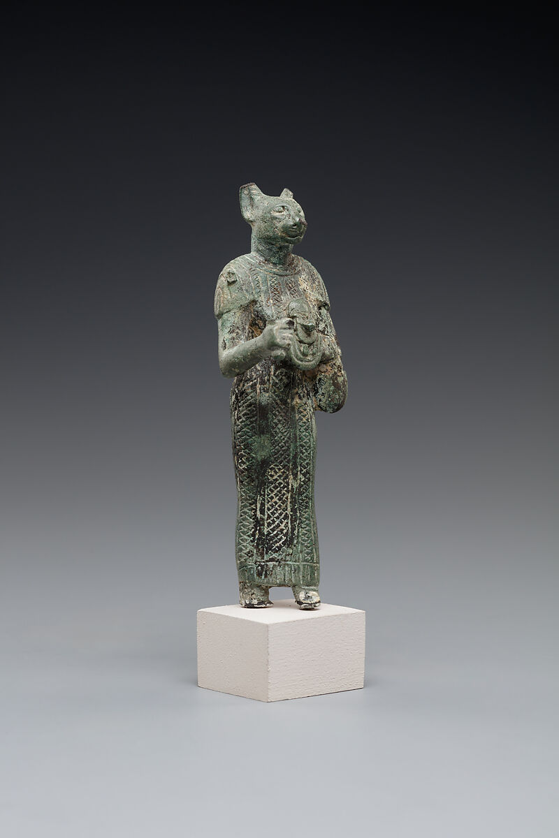 Bastet holding a lion-headed aegis, a sistrum (broken), and a basket, Bronze or copper alloy
