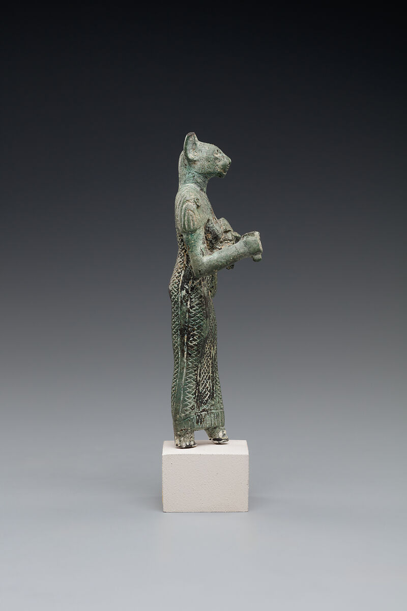 Bastet holding a lion-headed aegis, a sistrum (broken), and a basket, Bronze or copper alloy