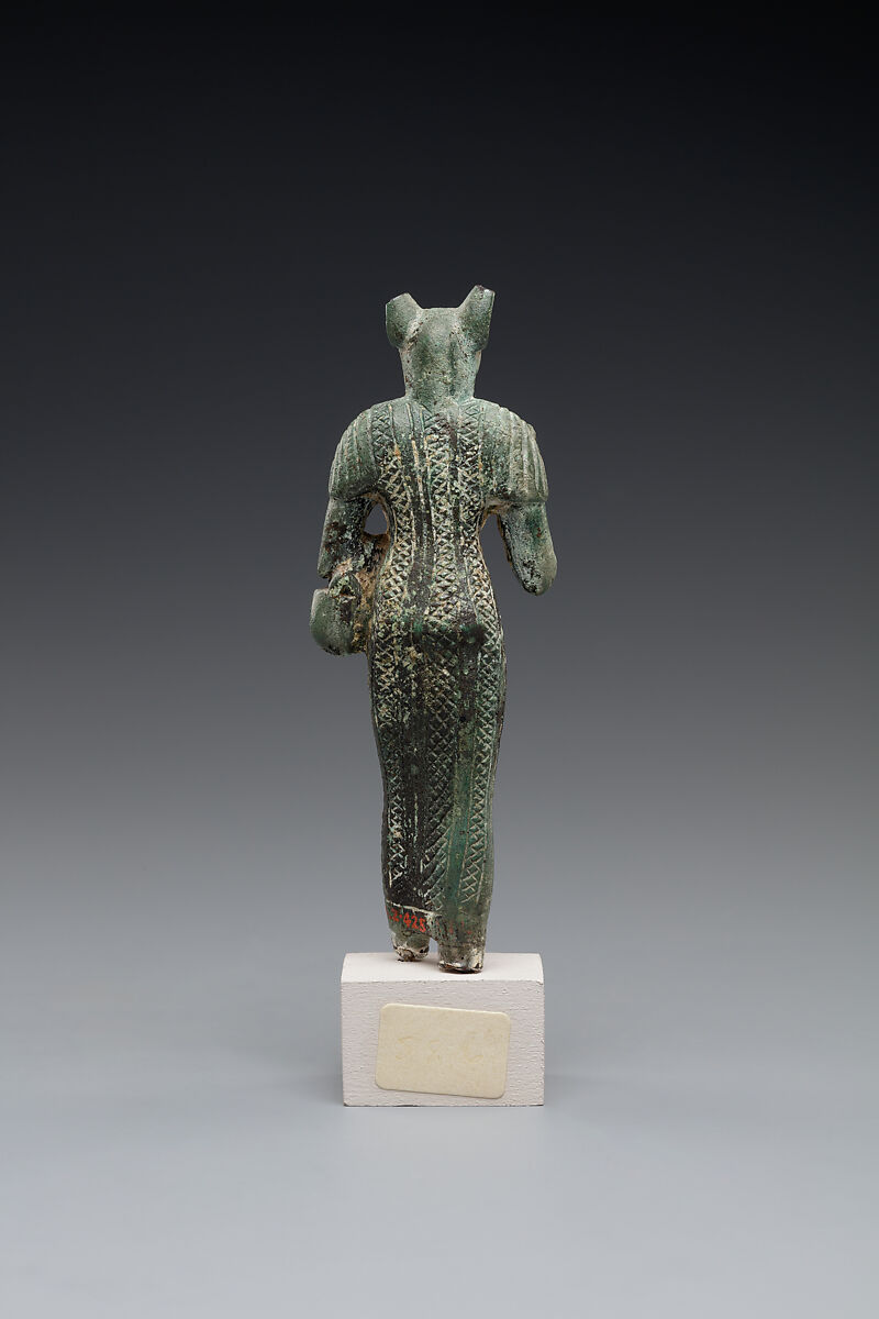 Bastet holding a lion-headed aegis, a sistrum (broken), and a basket, Bronze or copper alloy