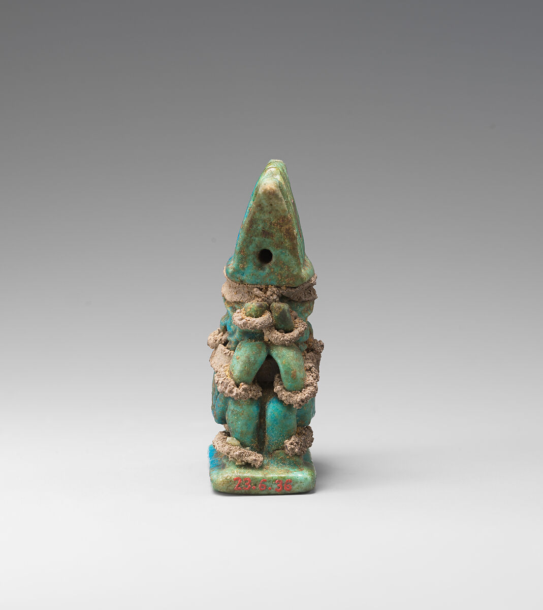 Amulet with twinned Bes-images, Green and blue faience, silver