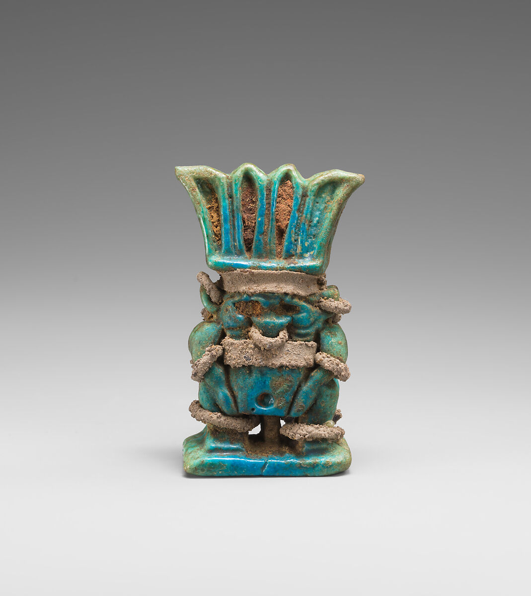 Amulet with twinned Bes-images, Green and blue faience, silver