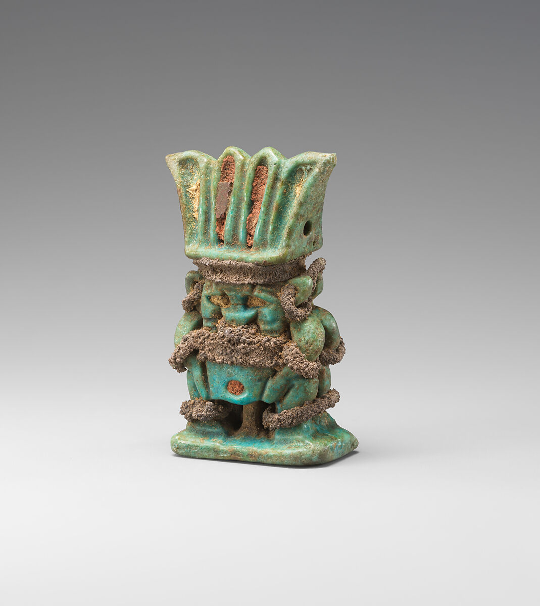 Amulet with twinned Bes-images, Green and blue faience, silver