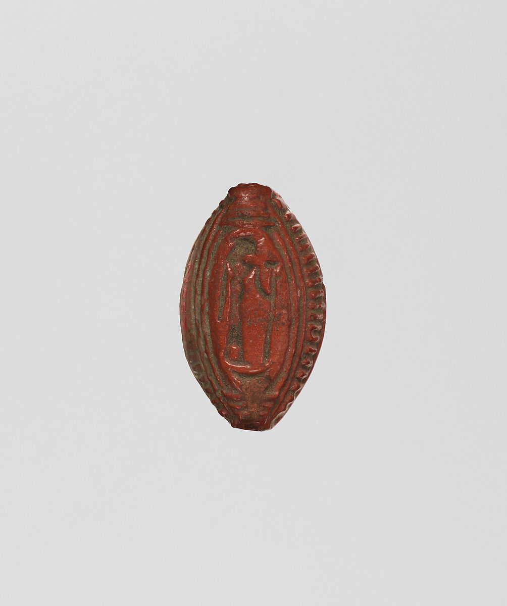 Cowroid with a standing female figure, Faience 