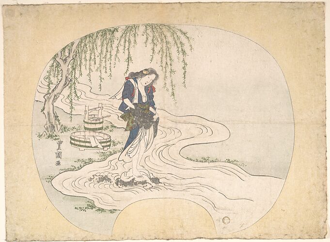 A Woman Stands on a Rock in a Stream Washing Clothes