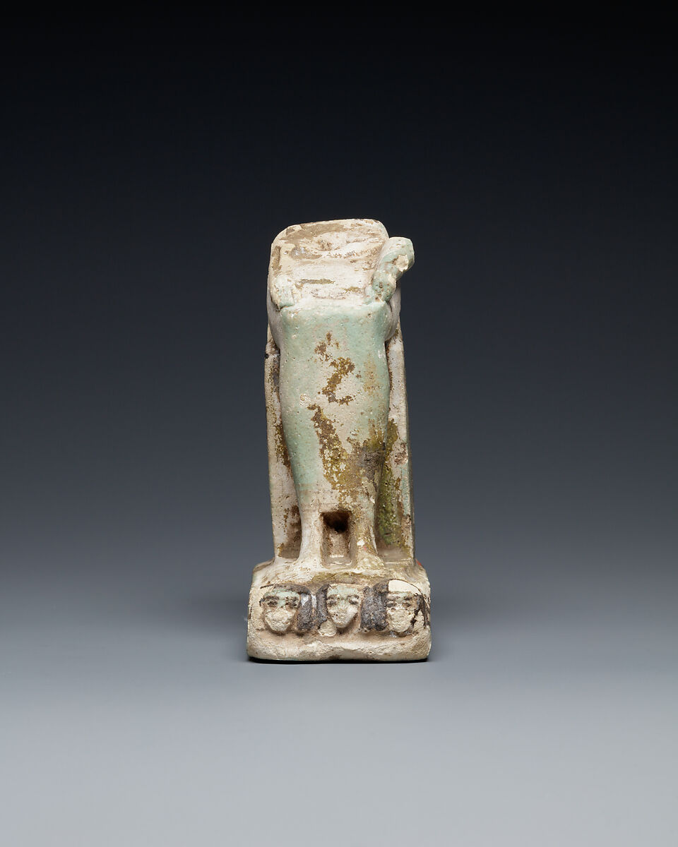 Lower half of a goddess on a throne with Bes figures, its base formed by prostrate captives, Faience
