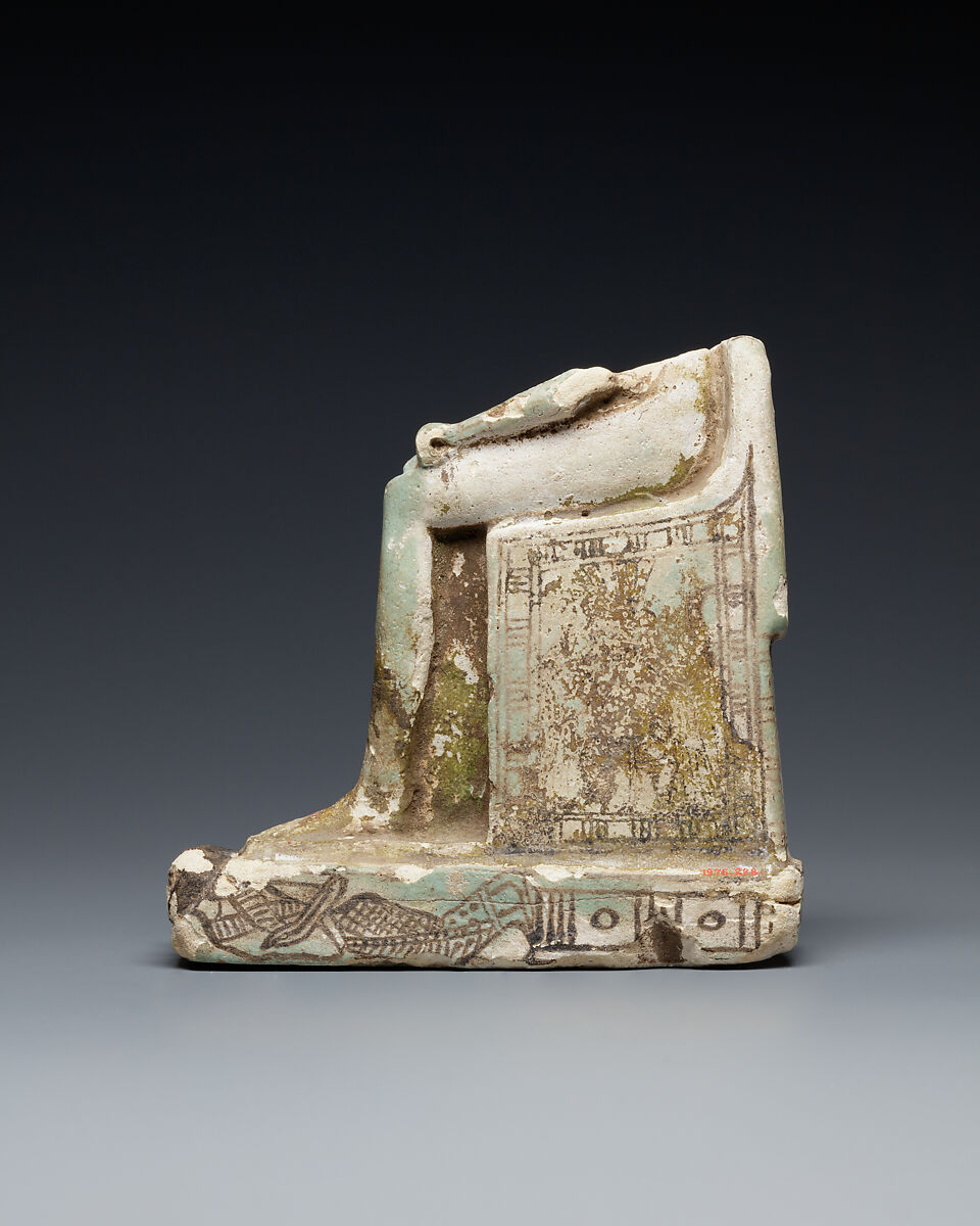 Lower half of a goddess on a throne with Bes figures, its base formed by prostrate captives, Faience