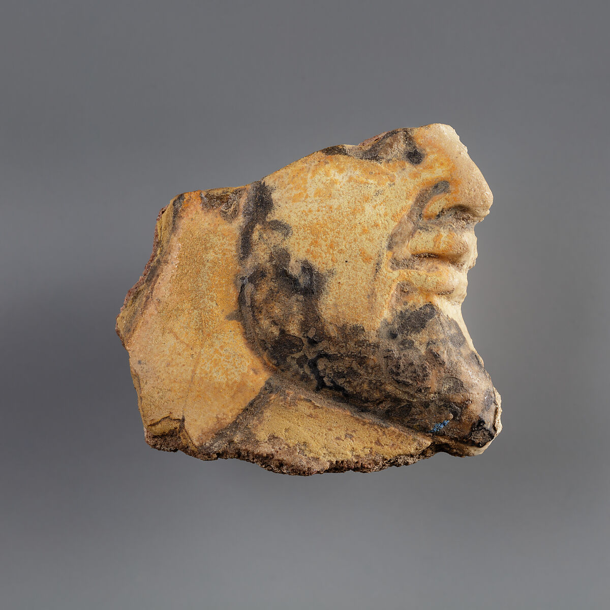 Tile with a head of a Mesopotamian captive from the palace of Ramesses II, Faience 