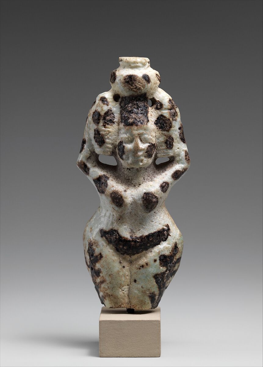 Nude female figure holding a vase on her head, Faience 