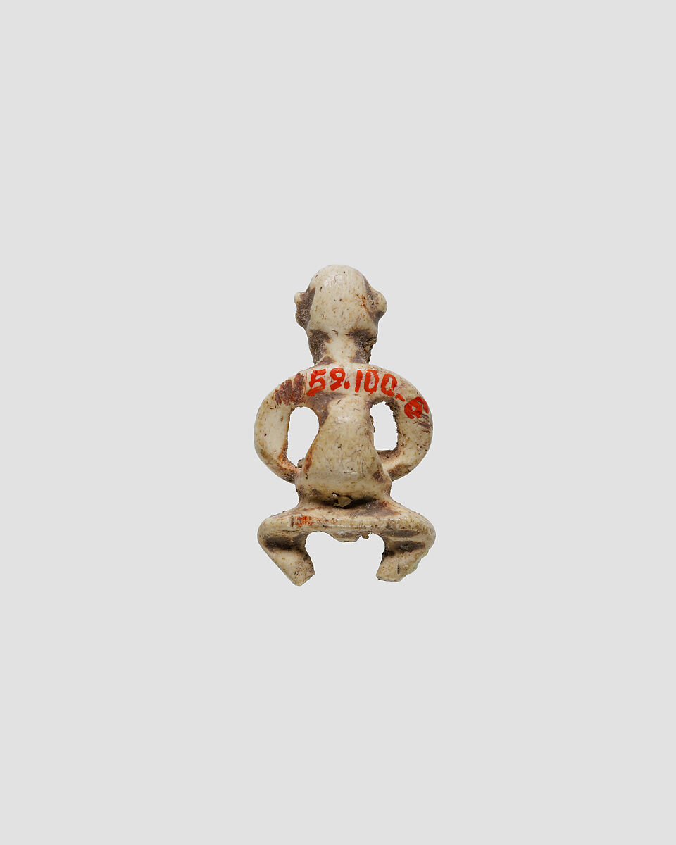 Dwarf amulet, Ivory or bone