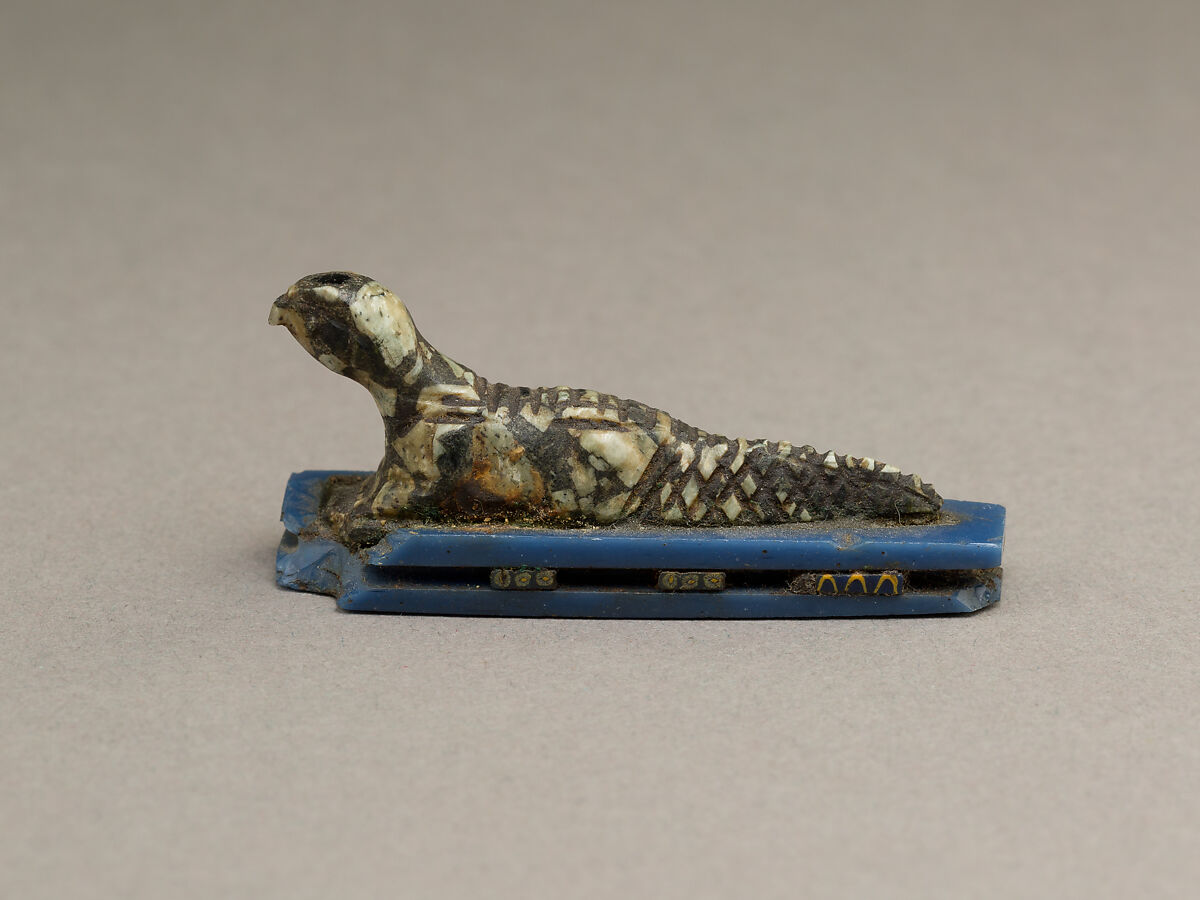 Falcon-headed crocodile, possibly Soknopaios, Stone or porphyry (?); base of glass