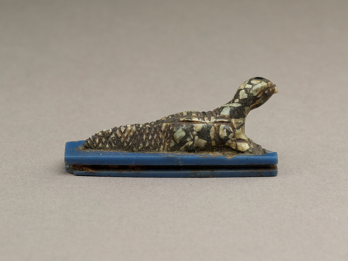 Falcon-headed crocodile, possibly Soknopaios, Stone or porphyry (?); base of glass