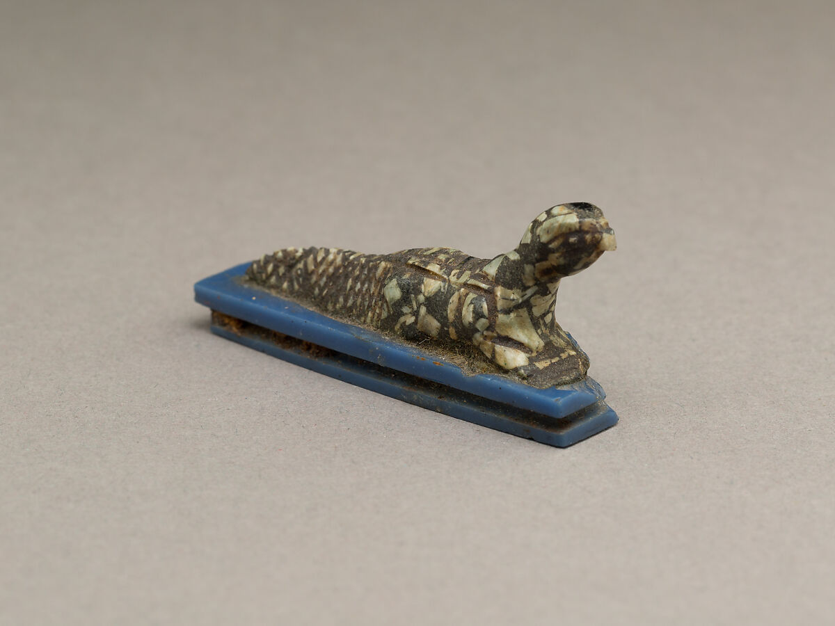Falcon-headed crocodile, possibly Soknopaios, Stone or porphyry (?); base of glass 