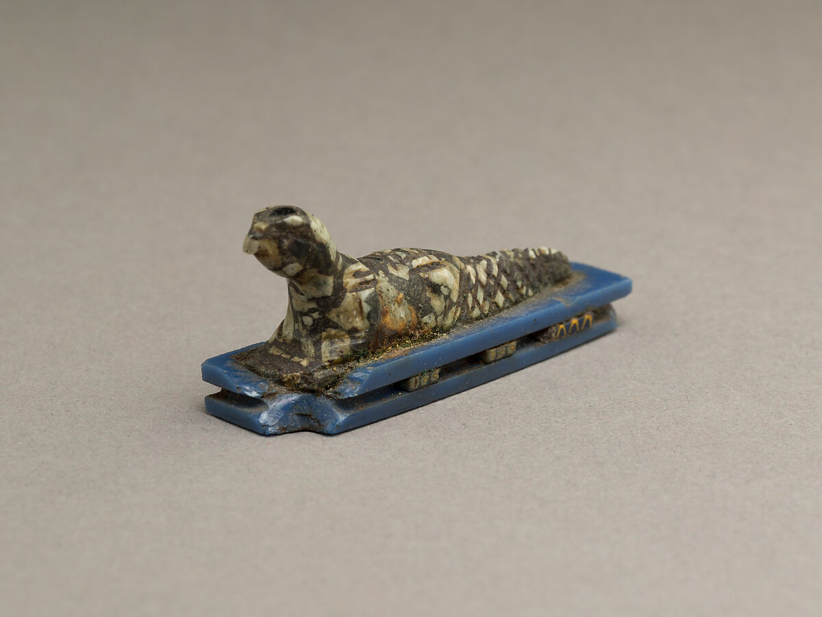 Falcon-headed crocodile, possibly Soknopaios, Stone or porphyry (?); base of glass