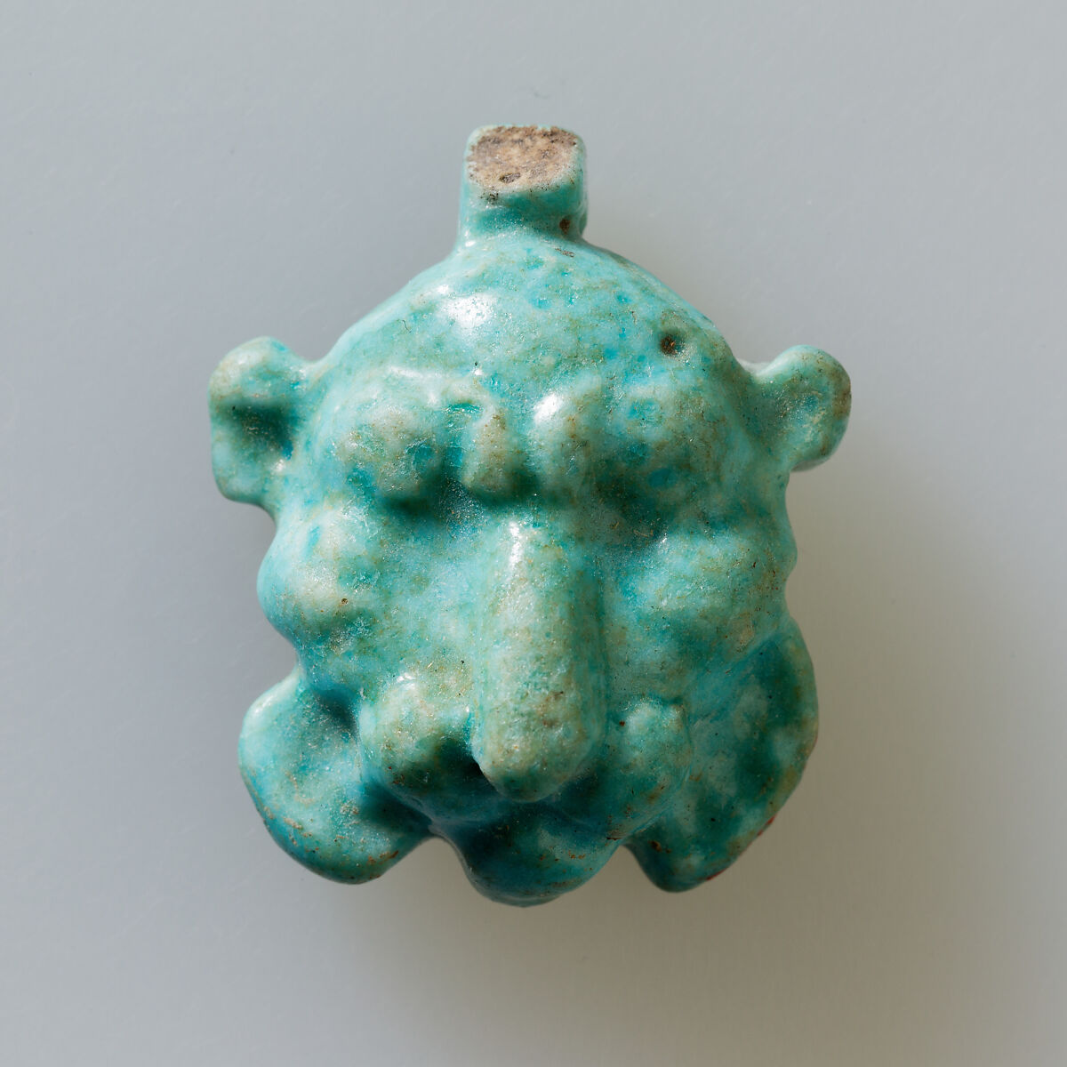 Lion head amulet, Faience 