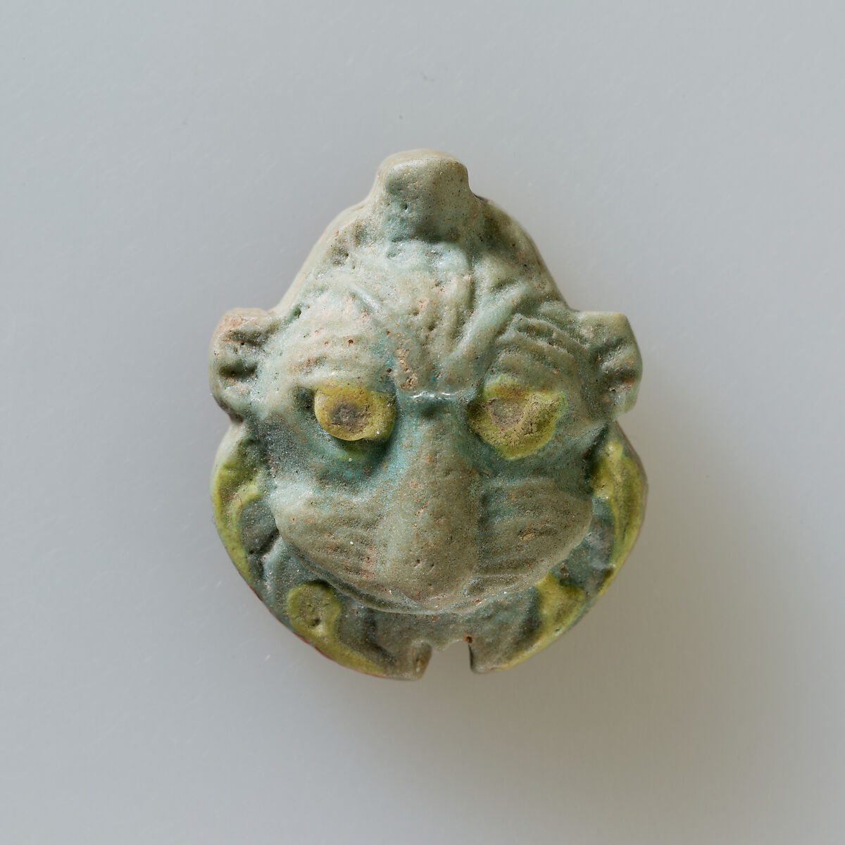 Lion head amulet, Green faience 