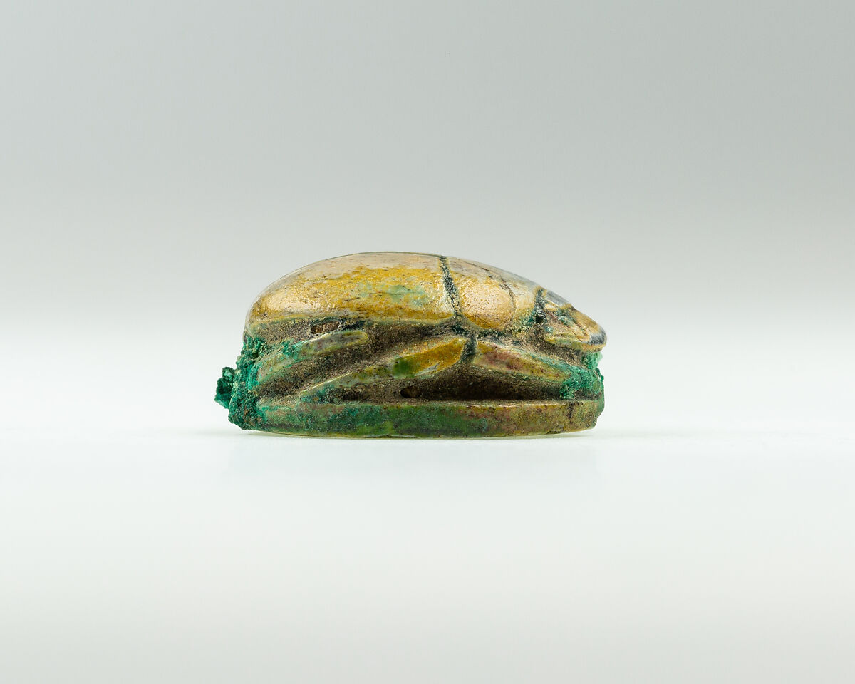 Scarab with device of baboon and falcon on base, Green glazed steatite