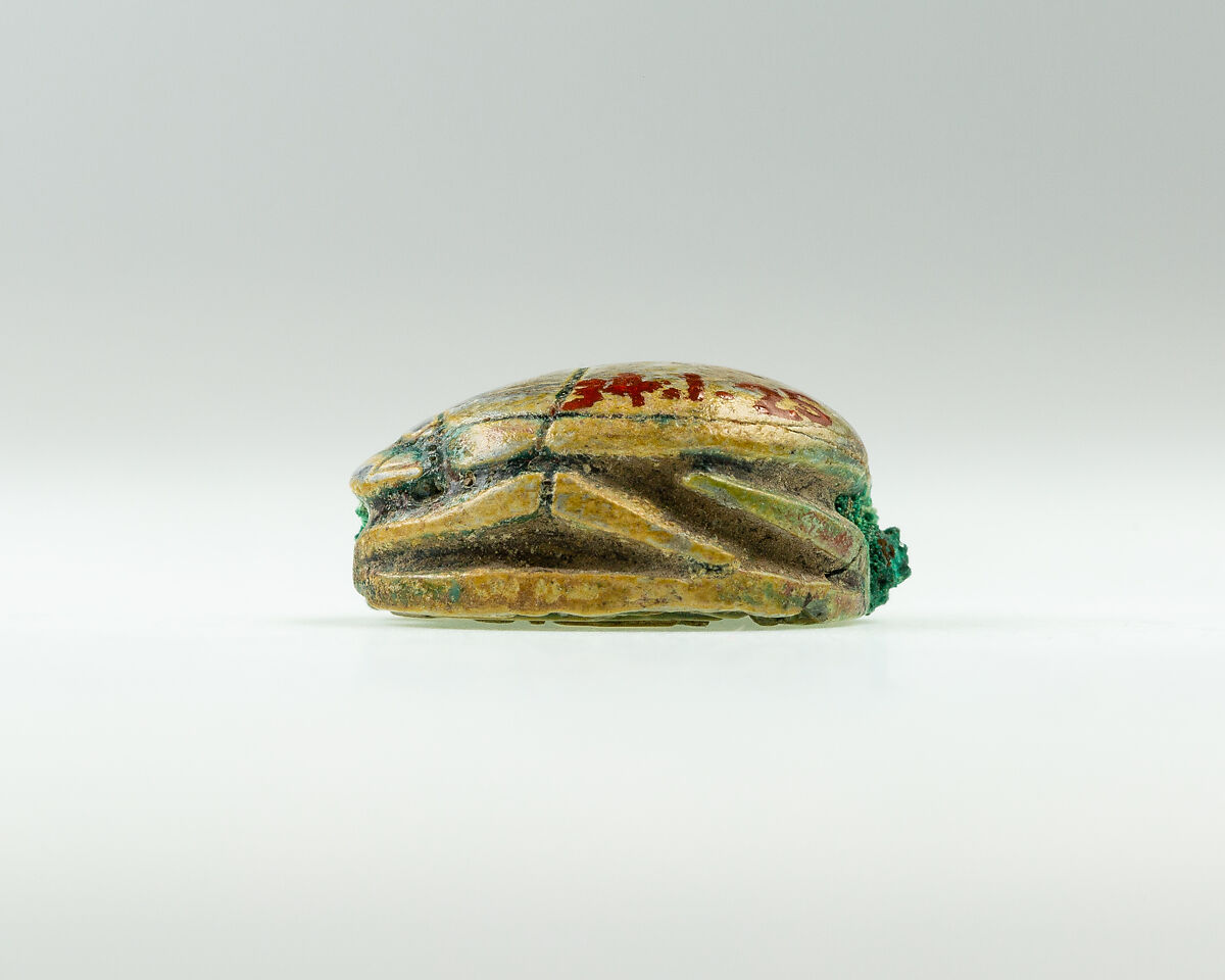 Scarab with device of baboon and falcon on base, Green glazed steatite