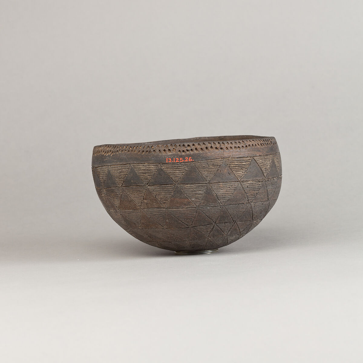 Drinking Cup, Polished black ware with traces of white filling.
