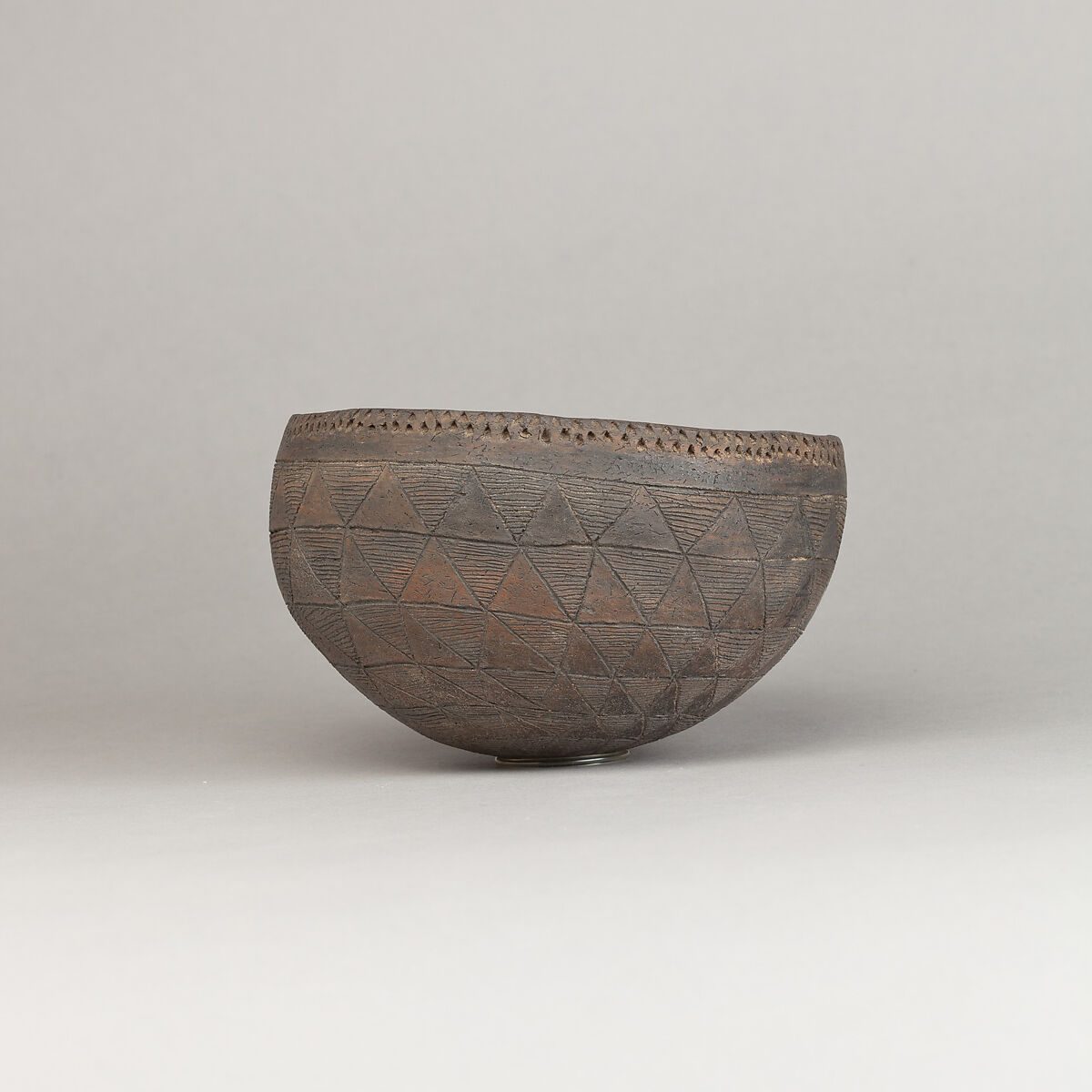 Drinking Cup, Polished black ware with traces of white filling.