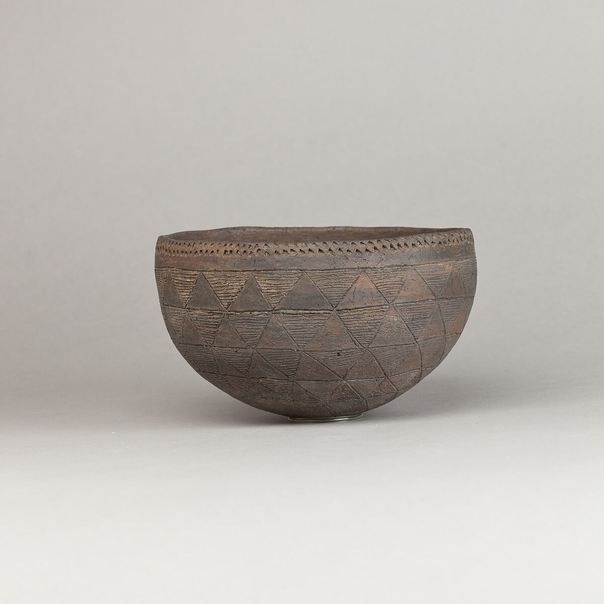 Drinking Cup, Polished black ware with traces of white filling.