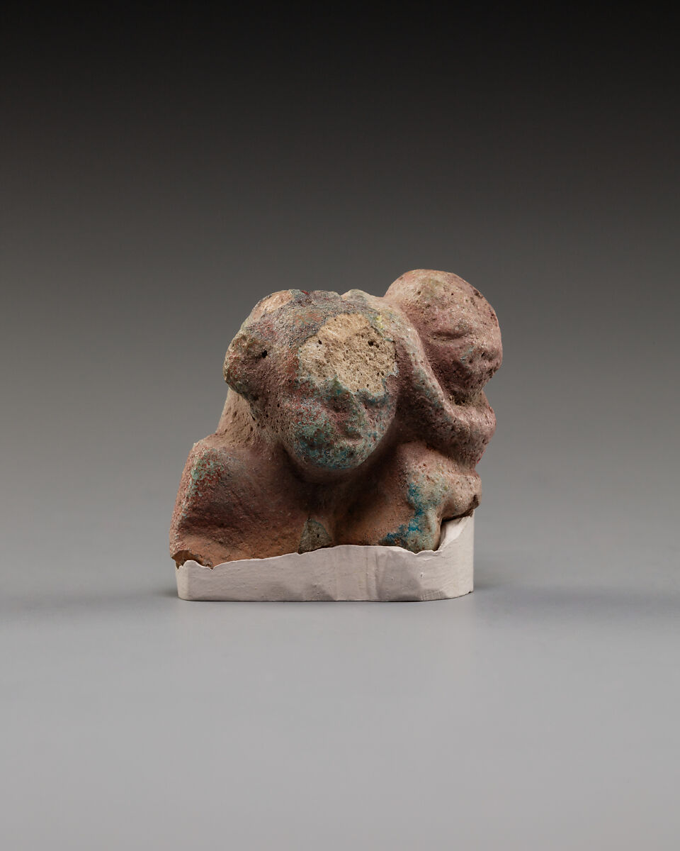 Upper part of a female figure with a child, Faience 
