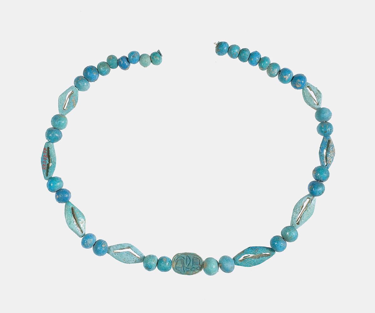 String of  ball beads, cowrie-styled beads, and a scarab, Faience, glazed steatite