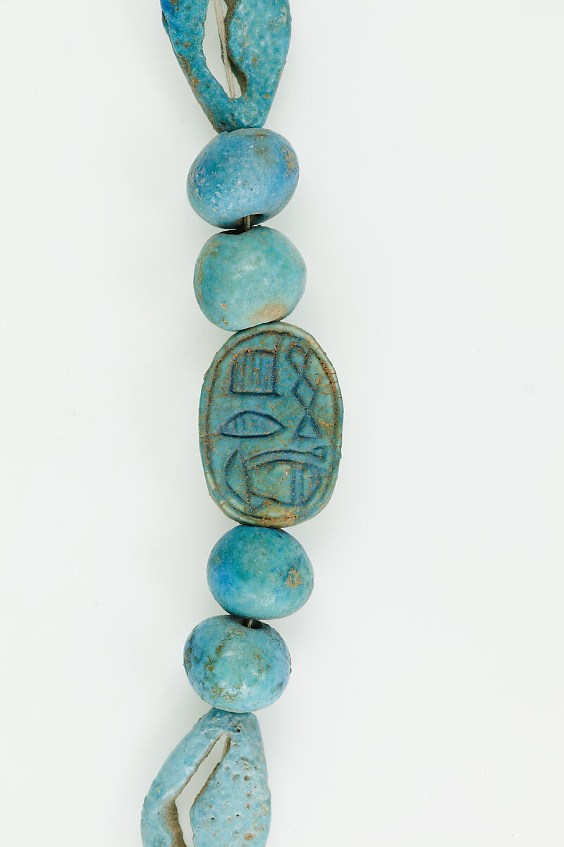 String of  ball beads, cowrie-styled beads, and a scarab, Faience, glazed steatite