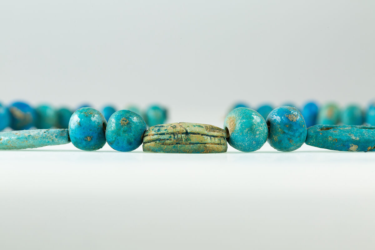 String of  ball beads, cowrie-styled beads, and a scarab, Faience, glazed steatite