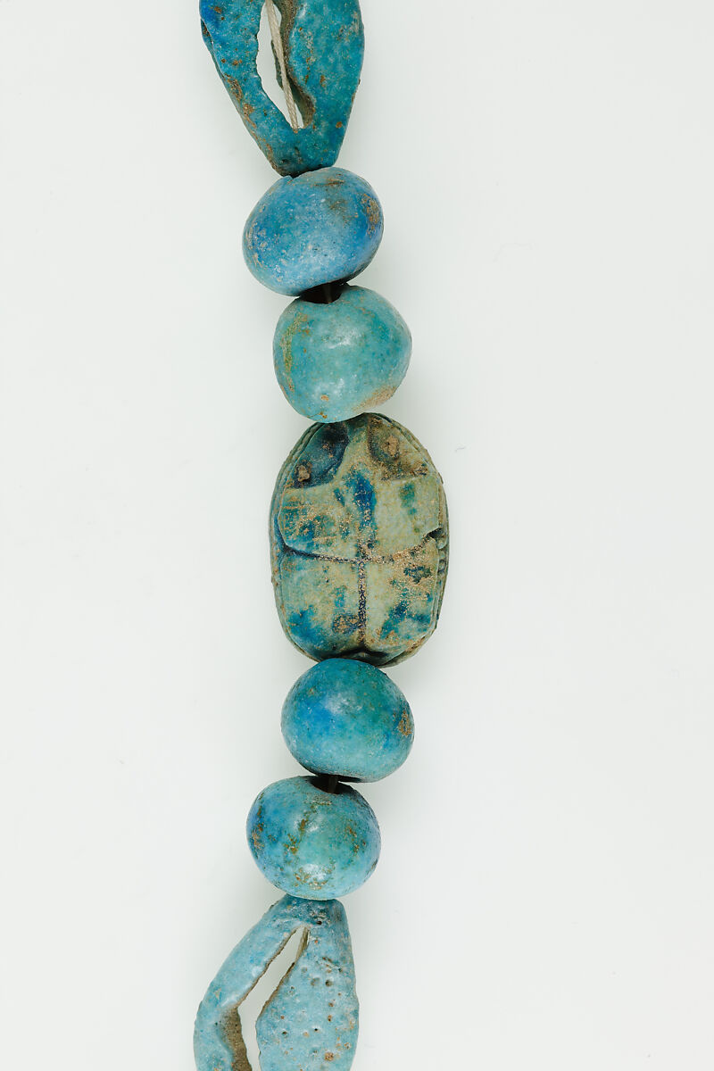 String of  ball beads, cowrie-styled beads, and a scarab, Faience, glazed steatite