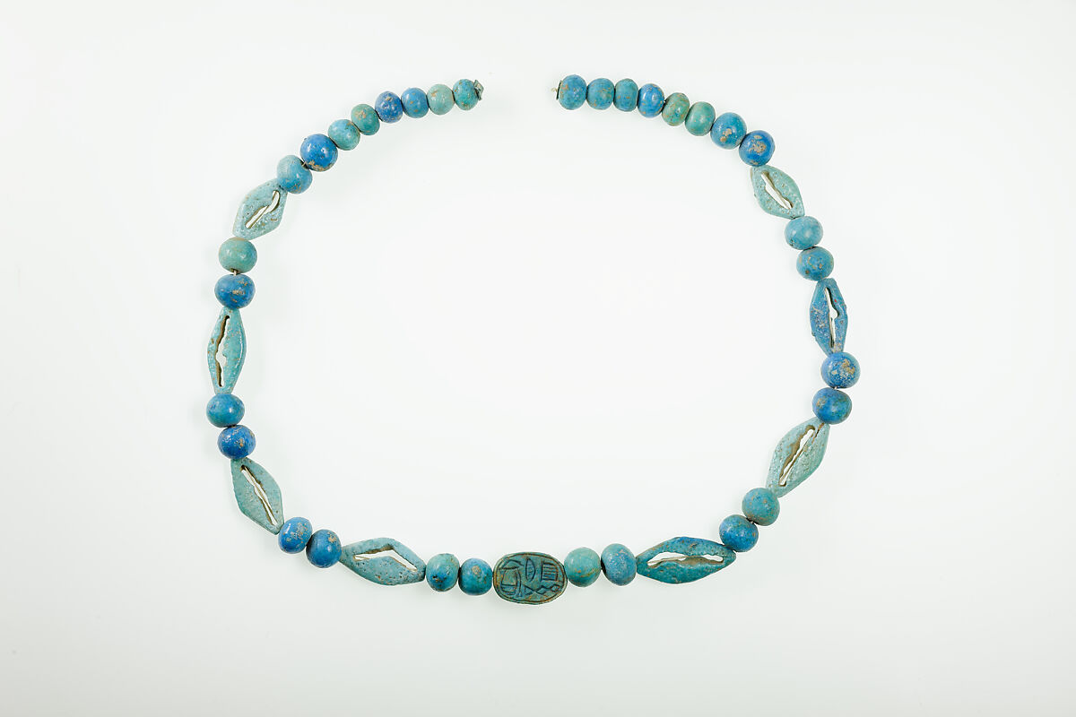 String of  ball beads, cowrie-styled beads, and a scarab, Faience, glazed steatite