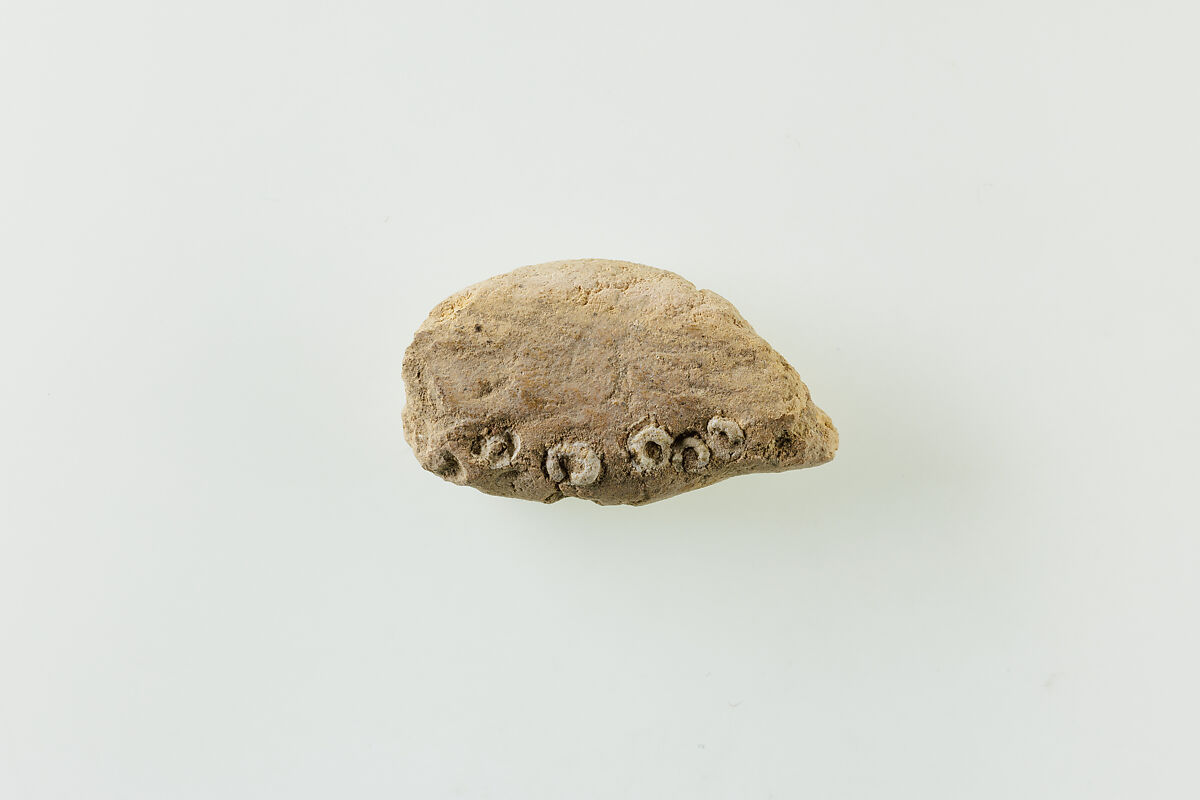 Fragment of clay lump with imbedded ring beads, Low-fired whitish clay, faience 