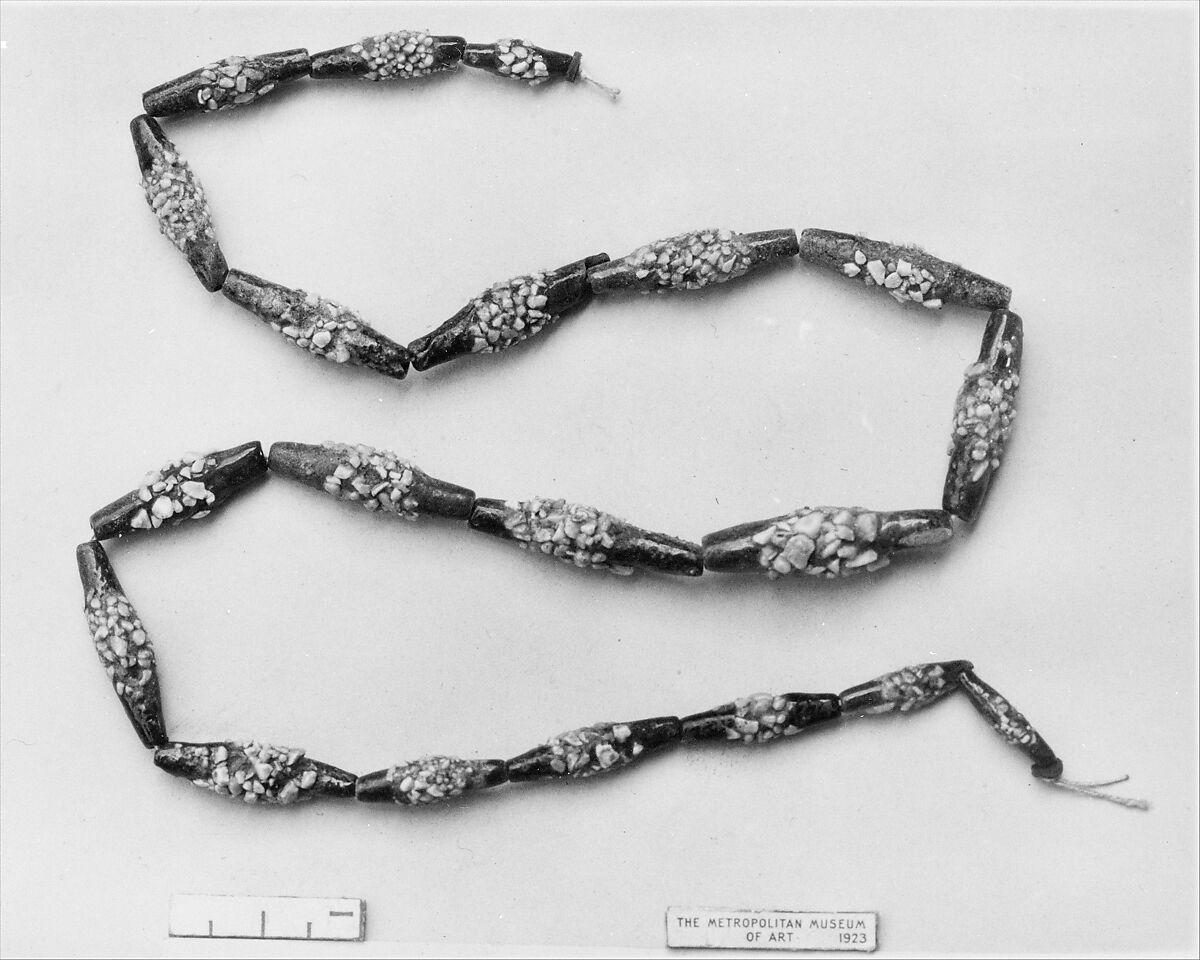 String of black faience beads with encrustations, Blue and black faience