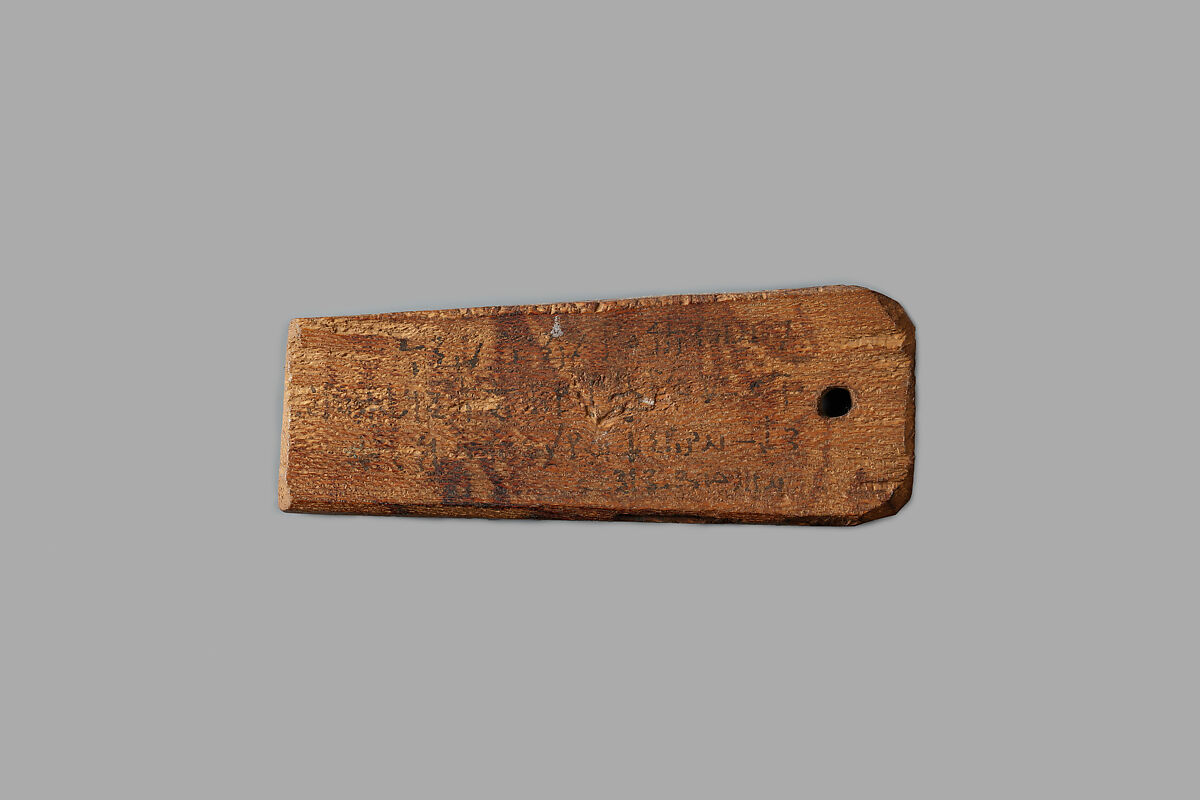 Mummy label of Senpnouthe, daughter of Sulis; her mother Taphiomis, Wood, ink 