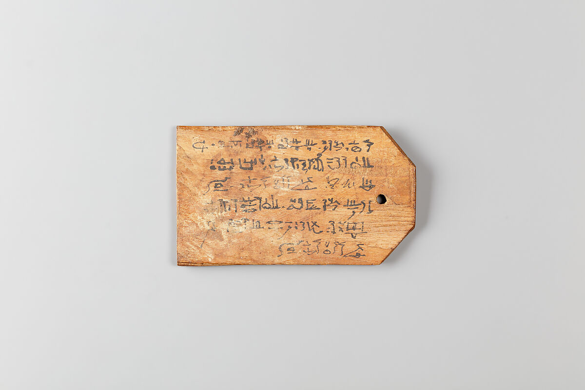 Mummy label of  Petemin, the son of Petempto, whose father was Petemin the Younger; his mother Thatre, Wood, ink 