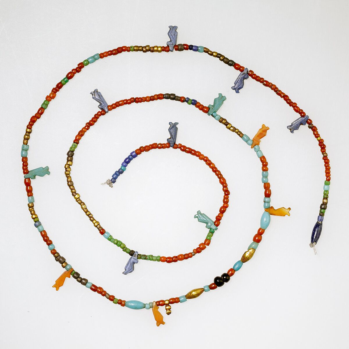 String of tiny disk beads, barrels, and 13 Taweret amulets, Gold, glass, carnelian 